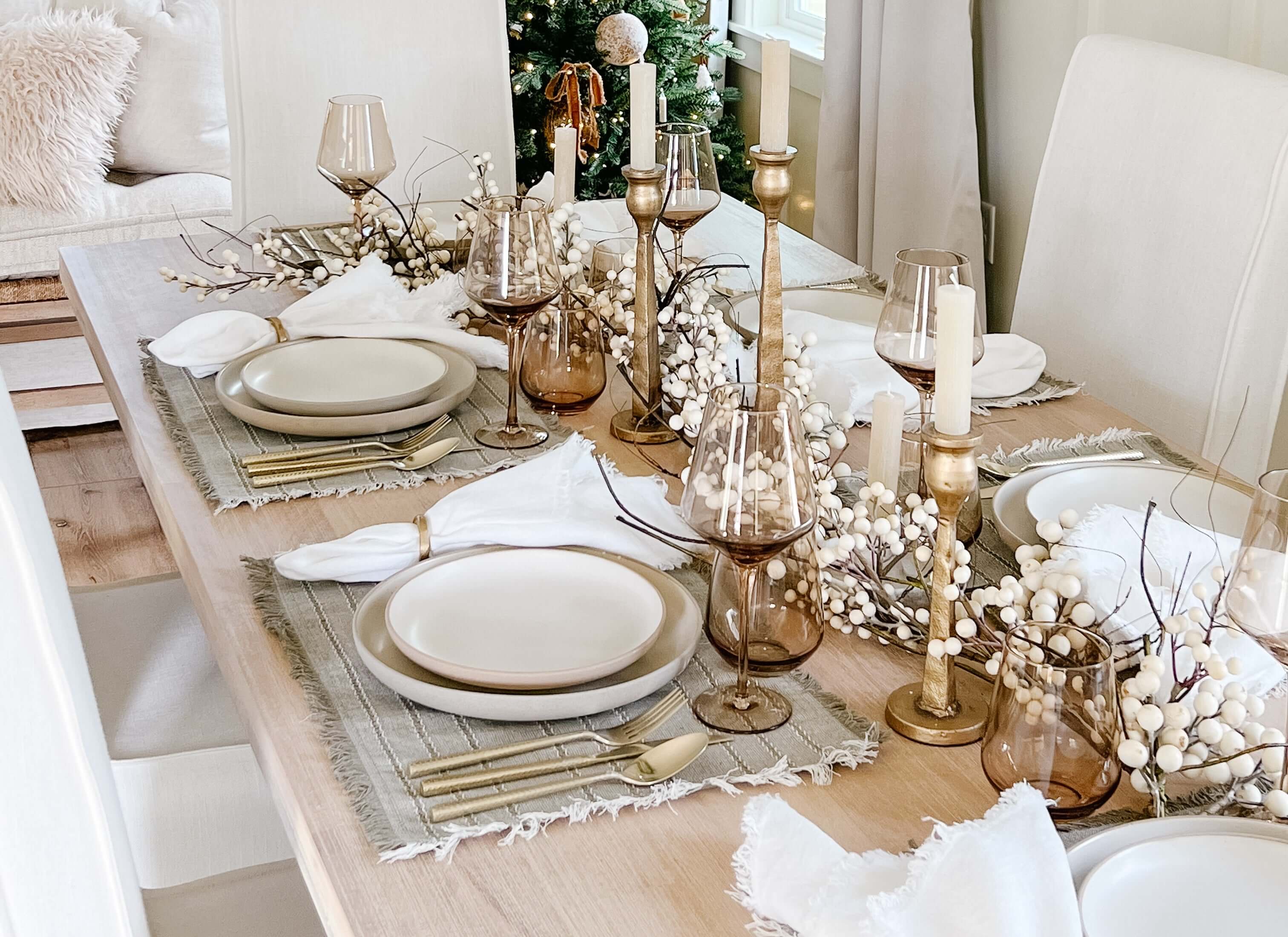Christmas table with linen runner and layered textures.
