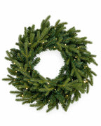 28 in Alpine Fir artificial Christmas wreath, glowing with warm white LED lights, above a mantel garland with gold reindeer