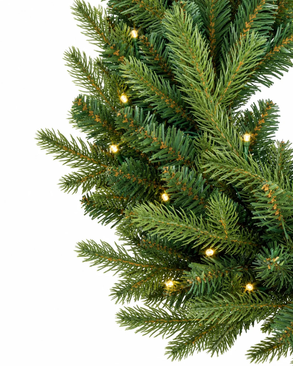 King of Christmas 9' x 16" Alpine Fir Artificial Christmas Garland with warm white LED lights draped elegantly over a rustic wooden mantel and stone fireplace.