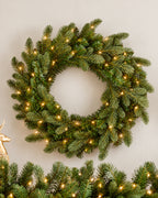 28 in Cypress Spruce artificial Christmas wreath, glowing with warm white LED lights