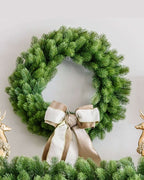 28 in Royal Fir artificial Christmas wreath, pre-lit with warm white LED lights, with a cream ribbon bow between gold reindeer