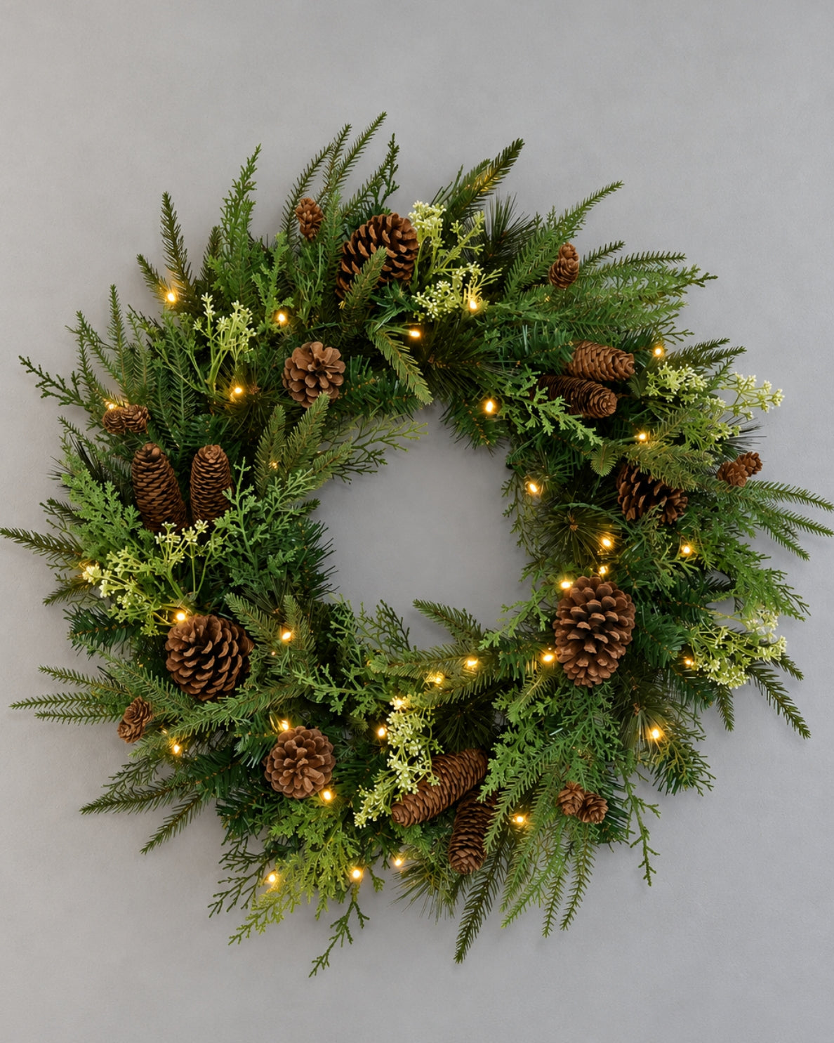 28 in Woodland Lodge artificial Christmas wreath with pinecones, glowing with warm white LED lights