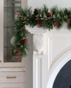 9 ft Redwood artificial Christmas garland, pre-lit with warm white LED lights, draped over a white fireplace mantel