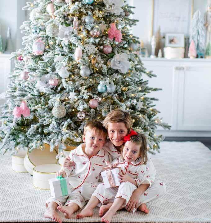 Children under a decorated flocked tree, King of Christmas customer photo by @taraturnure