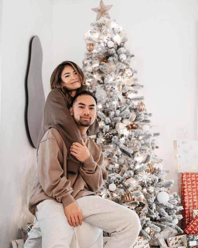 Couple beside a flocked tree, King of Christmas customer photo by @tthdee
