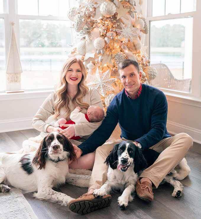 Couple with two spaniels by a flocked tree, King of Christmas customer photo by @alexishardygreene