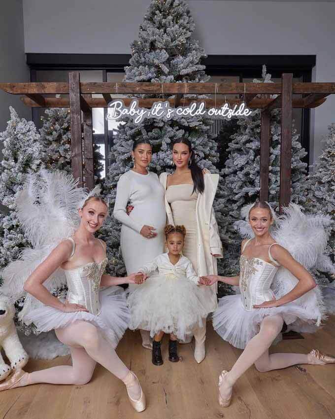Dancers in white costumes among flocked trees on a stage, King of Christmas customer photo by @eliteentertainmentglobal