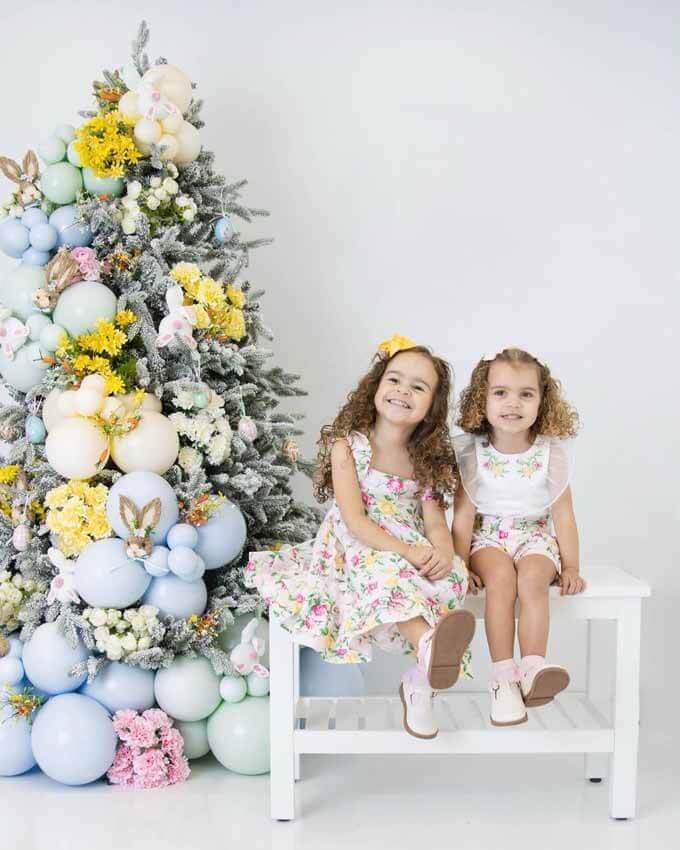 Two girls beside a pastel-decorated tree, King of Christmas customer photo by @indie_bee_