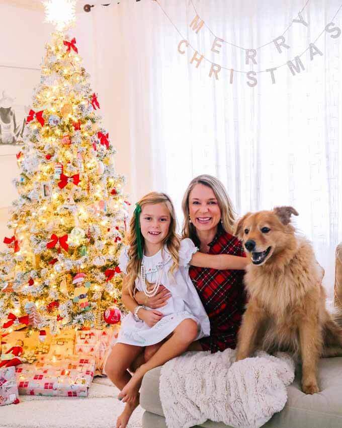 Mother, daughter and golden retriever by a lit tree, King of Christmas customer photo by @capecodmomma