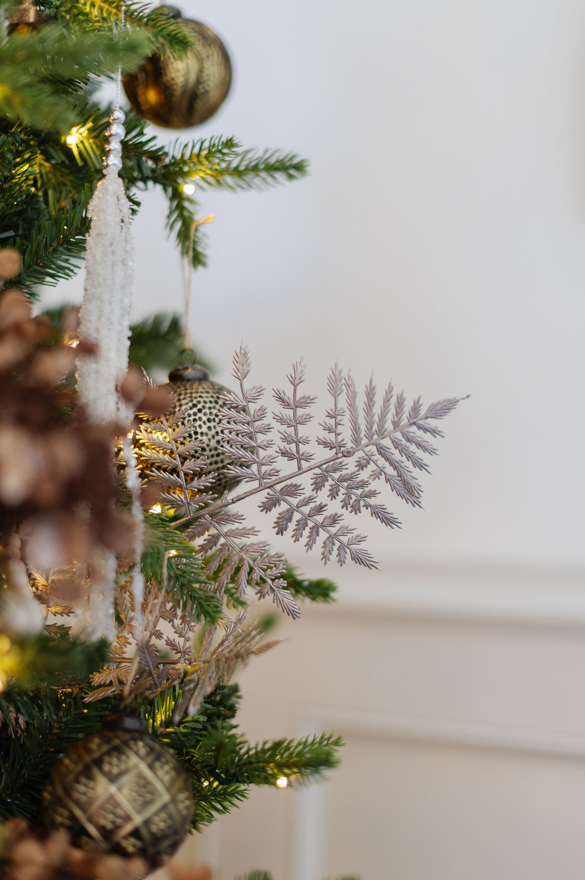 King of Christmas Rosegold Leaf Picks (12 Pack) on a decorated Christmas tree