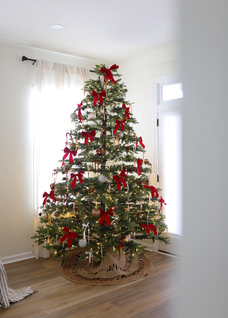 Rushmore Fir artificial Christmas tree, decorated with red ornaments in a bright room