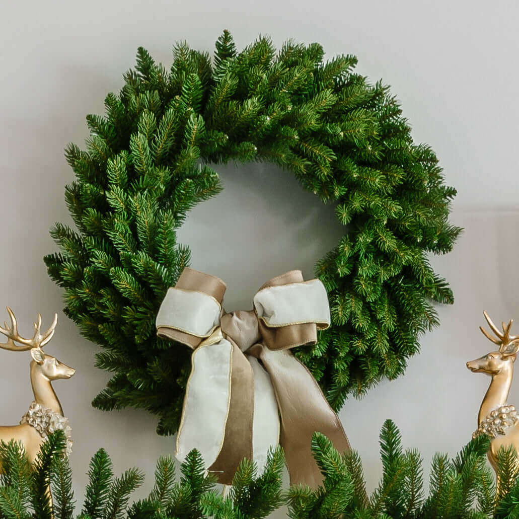 King Fraser Fir artificial Christmas wreath with a ribbon bow between gold reindeer