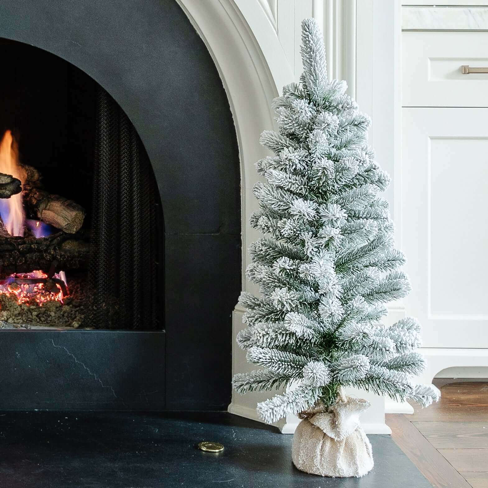 A tabletop King Flock flocked Christmas tree from King of Christmas.