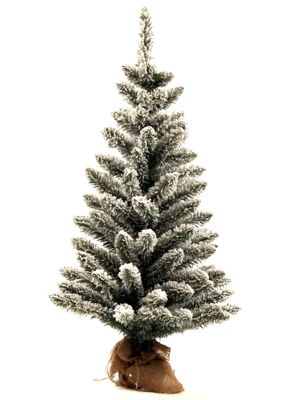 A flocked tabletop Christmas tree with a beige fabric base to hold it. 